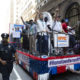 NYC Essential Workers Parade: red, white and blue float with people standing on it