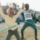 2024 KIDS COUNT data book: two black children hula-hooping happily