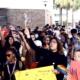 New Florida policy could out LGBTQ students to their parents: group of students with signs protesting