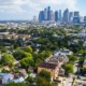 guide to reduce youth gun and gang/group violence: photo of city skyline in background and communities in foreground on a partly-cloudy day