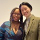 Asian-Black activism rekindled: A black woman and an Asian woman pose side by side, against a blank wall of a convention hall.