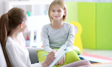 children's mental healthcare , child psychology research grants: young girl happy with therapist