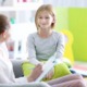 children's mental healthcare , child psychology research grants: young girl happy with therapist