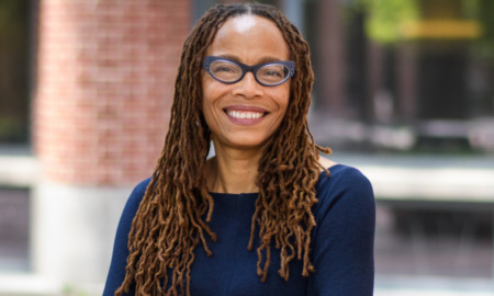 Dorothy Roberts: black woman with glasses and long hair standing outside