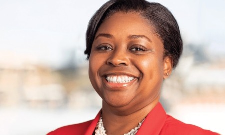 Dr. Gisele C. Shorter next president CEO of Nellie Mae: black woman with short hair and red blazer smiling