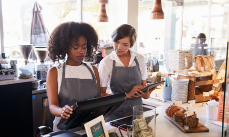 elevating youth worker voice toolkit: young employee receiving training on computer system at coffeeshop