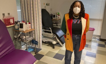 foster youth abortion access: medical worker stands in medical room with facemask on