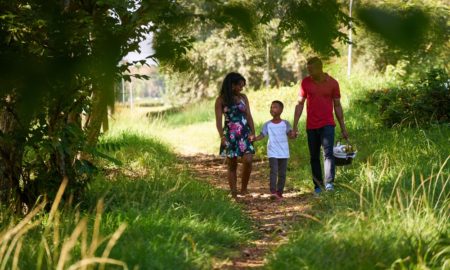 Community forest, Urban parks and green spaces for minority communities grants: happy black family walking in park