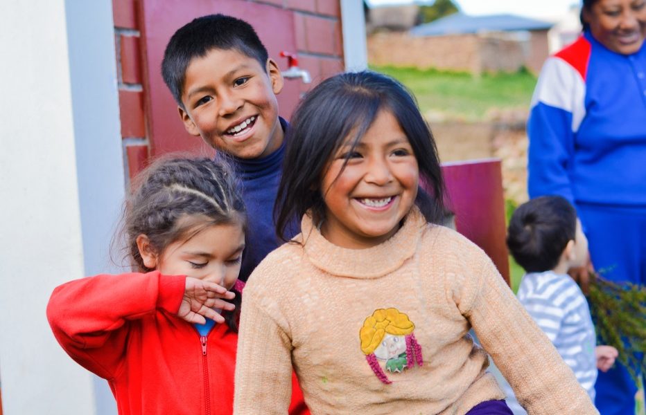 tribal college child care and welfare: happy native american children outside building