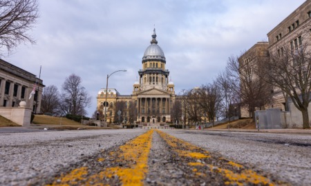 Illinois budget worsened foster care crisis: view of Illinois state capitol from rough road leading up to it.