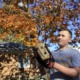 Inflation squeezes already pricey kids sports: boy with baseball glove looking at ball in the air in front of house and tree