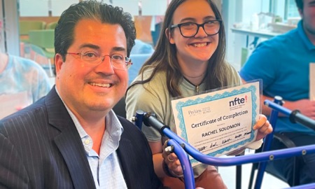 Rachel Solomon and J.D. LaRock: girl with long brown hair and glasses smiles while holding certificate next to man in glasses