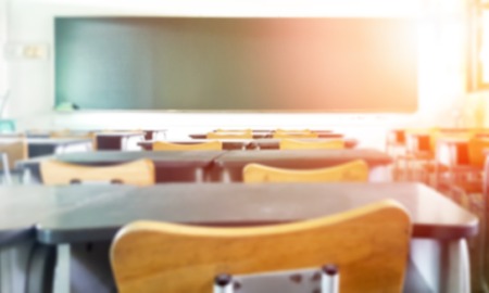 US schools now offer help with hunger, housing, healthcare: view of classroom from the back with chair-back in foreground