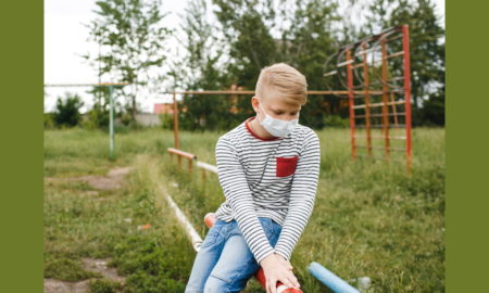 homeless: Teenage boy on playground in mask.