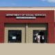 Missouri SNAP_ Red and tan commercial building under a blue sky with signage "Department of Social Services"