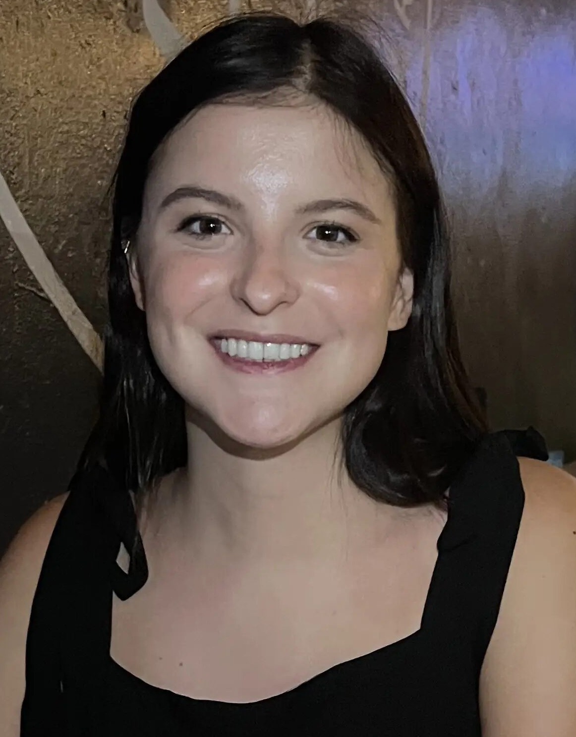 Desegregation academies: Headshot of young woman with long dark hair in sleeveless black top