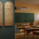 10 commandments in classroom: 2 stone tablets hang on wall at entrance to empty classroom