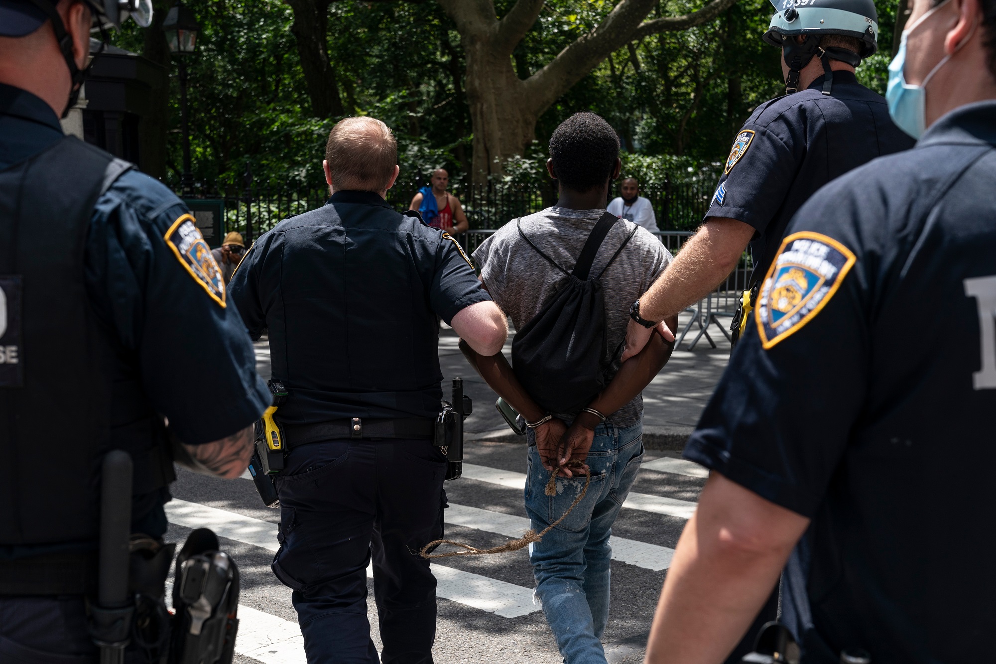 NYPD wrongly arresting black kids on Halloween: group of NYPD officers walking an arrested black youth across the street