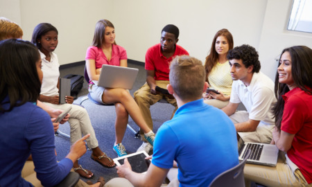 Restorative justice: Several high school students sit in a circle of chairs having a discussion