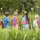 out-of-school time, outdoor learning grant: teacher and students in backpacks out in nature