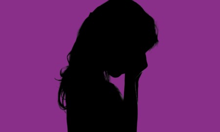 Pandemic-era funds for homeless students and youth: silhouette of young girl crying against purple background