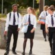 school choice, private schools push parents to exploit school voucher programs: group of private school students in uniform walking outside