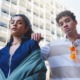 SYSTEM-INVOLVED YOUTH: FOUR TEENS WITH SERIOUS LOOKS ON THEIR FACES STAND NEXT TO EACH OTHER OUTSIDE IN FRONT OF A WHITE SKYSCRAPER