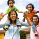 Report family dynamics: happy family portrait having fun outdoors at their home