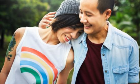 LGBTQ youth from immigrant families report: two happy LGBTQ youth embracing