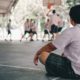 LGBTQ youth sports participation brief: sad youth watching other play basketball