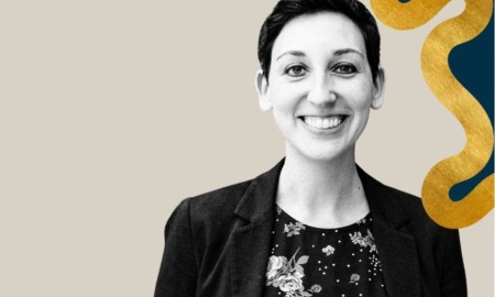 Shawna Rosenzweig president of Camp Fire: woman with short, dark hair smiling in front of graphic grey and colorful background