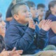 developing social and emotional competencies in OST programs: happy youths sitting on ground clapping