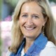 Stephanie Cornell executive director Walton Family Foundation: white woman with light hair in white shirt and blue scarf smiling outside