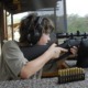 rural youth and guns study: young boy shooting a rifle at shooting range