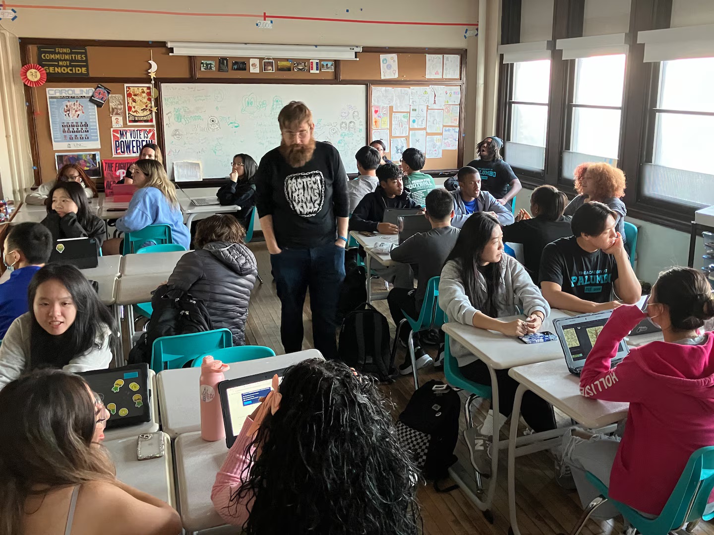 Teachers toss their lesson plans, give students the floor to grapple with Trump win: bearded teacher stands in classroom as students talk