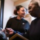 toll of his absence; women supporting prisoner Almeer Nance: older black woman looking at photo while younger woman looks off to the right