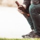 underage drinking prevention and reduction grants: youth sitting on bench drinking from bottle of wine