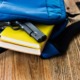 student threats, when students bring guns to schools: gun falling out of backpack on top of yellow book