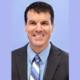 Greg Zweber newsmaker headshot; smiling man in suit and tie