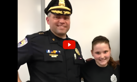 Sandra Birchmore justice: Young teen girl with brown hair pulled back stands smiling next to man in black police uniform and cap with hos arm around the girl's shoulders