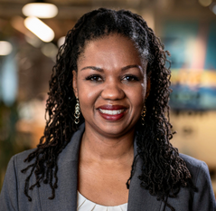 Restorative justice: headshot black woman with long black hair in gray suit and white blouse